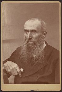 Portrait of a man with sideburns and a beard