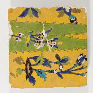 An 18th century Persian pottery tile in yellow