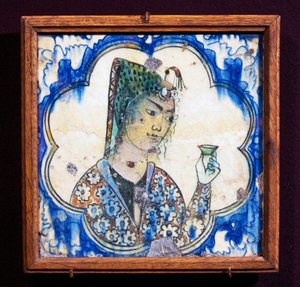 Ceramic tile depicting young woman holding vase