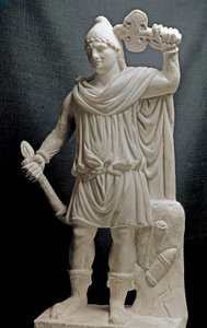 Mithraic Divinity Holding a Torch and a Double Axe (2nd or 3rd century AD). Marble Sculpture. Louvre Museum, Paris