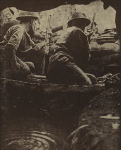 Australian soldiers in a water-filled rifle pit, Sanananda, New Guinea, World War II by Photographer Australian