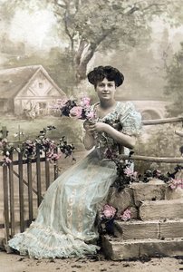 Woman with garland of flowers, postcard, c. 1900