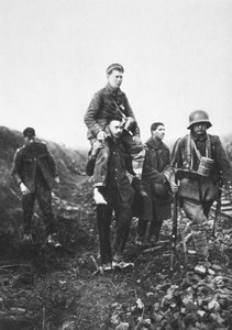 A German Infantry Soldier with a Wounded Leg is Carried from Battle by English Prisoners of War by Photographer German