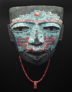 Funeral mask covered by turquoise and red shell mosaic. Artifact from Teotihuacan, Mexico City. Teotihuacan Civilization - Precolombian art: funeral mask of turquoise and pink stones dating from the civilization of Teotihuacan III (300-650 AD)