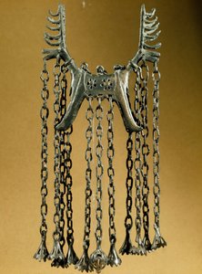 Elk shaped pendant with two heads from a site in Dolanlar. Bronze Age. Azerbaijan State Religion History Museum, Baku by Prehistoric Prehistoric
