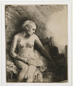 A woman at the bath with a hat beside her