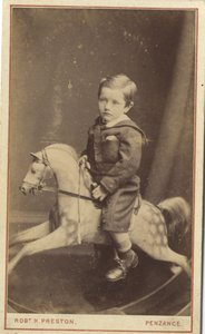 Young boy sitting on a rocking horse