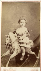 Young girl sitting on a rocking horse