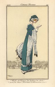 Woman reading a letter wearing a dress and toque hat of sea-green silk velvet edged with ermine. Ermine shawl and muff, Handcoloured pochoir etching after an illustration by Roger Broders from Tommaso Antongini’s Journal des Dames et des Modes