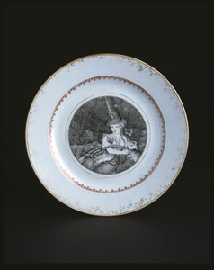 White plate bordered in gold and red with woman