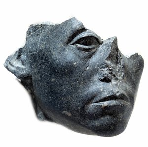 Ancient Egyptian Art: Head of King Sesostris III. Statue fragment. Black granite sculpture, circa 1900 BC