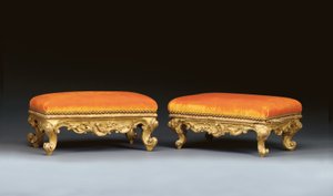 A matched pair of Italian rococo giltwood footstools by School Italian