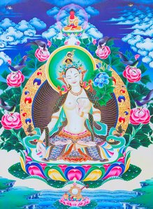 Image Depicting the White Tara, the Seven Eyed Divine Mother Seated on a Lotus with Her Right Hand in Varada Mudra Position Symbolising Generosity