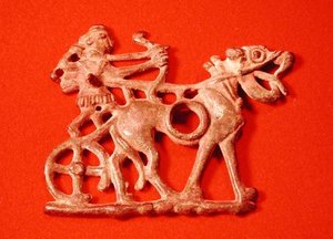 Horse bit depicting a hunter on his chariot, firing his bow, c.1200-700 BC