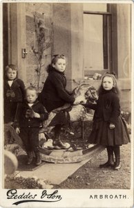 Group of young children and their rocking horse