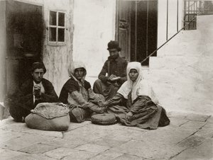 Women grinding flour with round millstones within a courtyard of a house in Jerusalem by Sergeant Henry Phillips