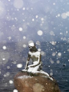 Snow storm on The Little Mermaid statue by Edvard Eriksen, winter in Copenhagen Denmark, 2022 by Sisse Brimberg