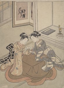 Two Young Women Seated by a Kotatsu Playing Cat