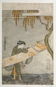 Young woman tending a kakemono attaches to a tree