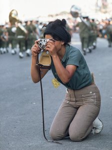 Israeli woman takes photograph of Passover military parade in Jerusalem by Ted Spiegel