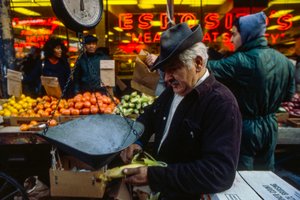 Man Peeling an Ear of Corn at market, Philadelphia
