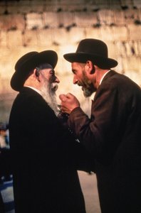 Orthodox Hasidic Jewish men discuss fine points of law at the Western Wall