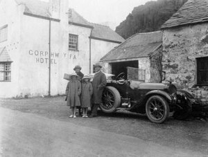 A family standing beside their car, Gorphwysfa Hotel, North Wales