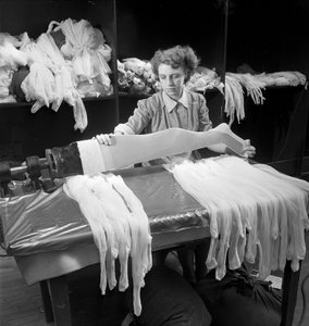 A female worker inspects woolen tights at the Aristoc mill