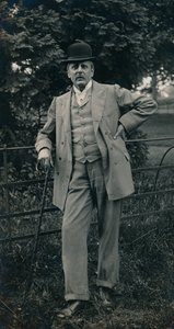 A gentleman wearing a suit and bowler hat