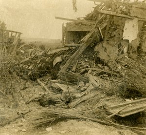 Bombed out building, body of dead soldier in foreground