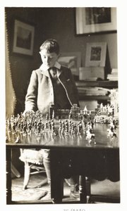 Boy playing with toy soldiers, c 1912