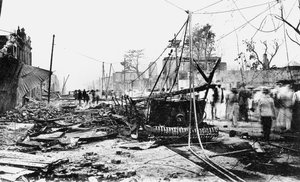 Earthquake damage and a burnt car, King Street, Kingston, Jamaica