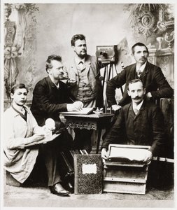 Group of photographers and assistants with equipment by Unbekannt