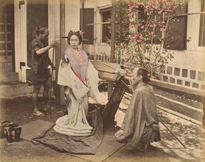 Japanese Woman in Traditional Dress Posing with Two Men, 1870s