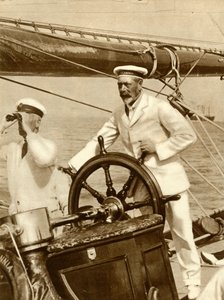 King George V at the wheel of his yacht, Britannia, during Cowes Regatta week