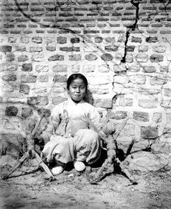Korean girl with dolls, 1900