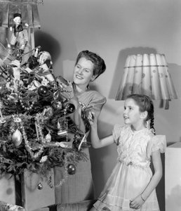 Woman and girl decorating a Christmas tree, c 1948 by Unbekannt