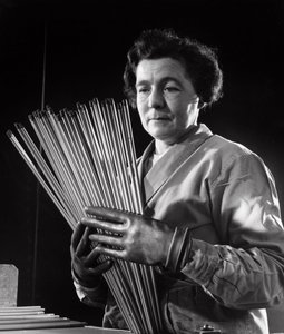 A female employee with rods of carbon electrodes used by arc welders