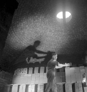 A kiln worker stacks tiles for firing, Wheatley Quarries