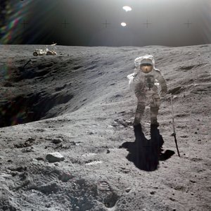 Charles M. Duke, Jr., lunar module pilot of the Apollo 16 mission, collecting lunar samples at the rim of Plum Crater, April 1972