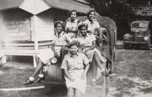 Five members of the West Indies Auxiliary Territorial Service sitting on a military vehicle by Unbekannt