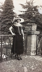 Portrait of a woman leaning against the balustrade of a terrace