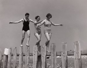 Two women and a man walking along a groyne, c 1930s by Unbekannt