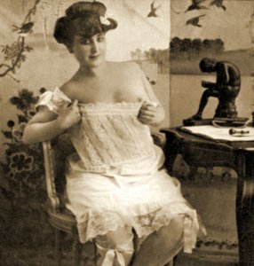 Young woman displaying a lacy chemise, c.1900
