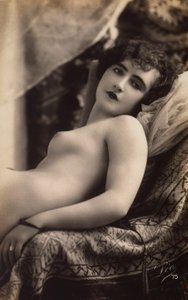 A Young Woman Posing Nude on a Couch by Unknown photographer