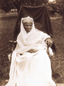 Harriet Tubman, full-length portrait, seated in chair, facing front, probably at her home in Auburn, New York