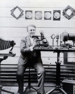 Photo of Thomas Alva Edison in front of his phonograph by Unknown photographer