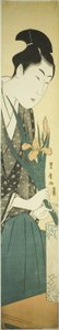 Young man arranging irises in a vase