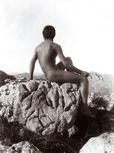 Young man posing on a rock by Wilhelm Baron von Gloeden