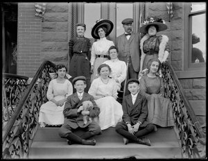 Bease group portrait: men, women, children, and small dog